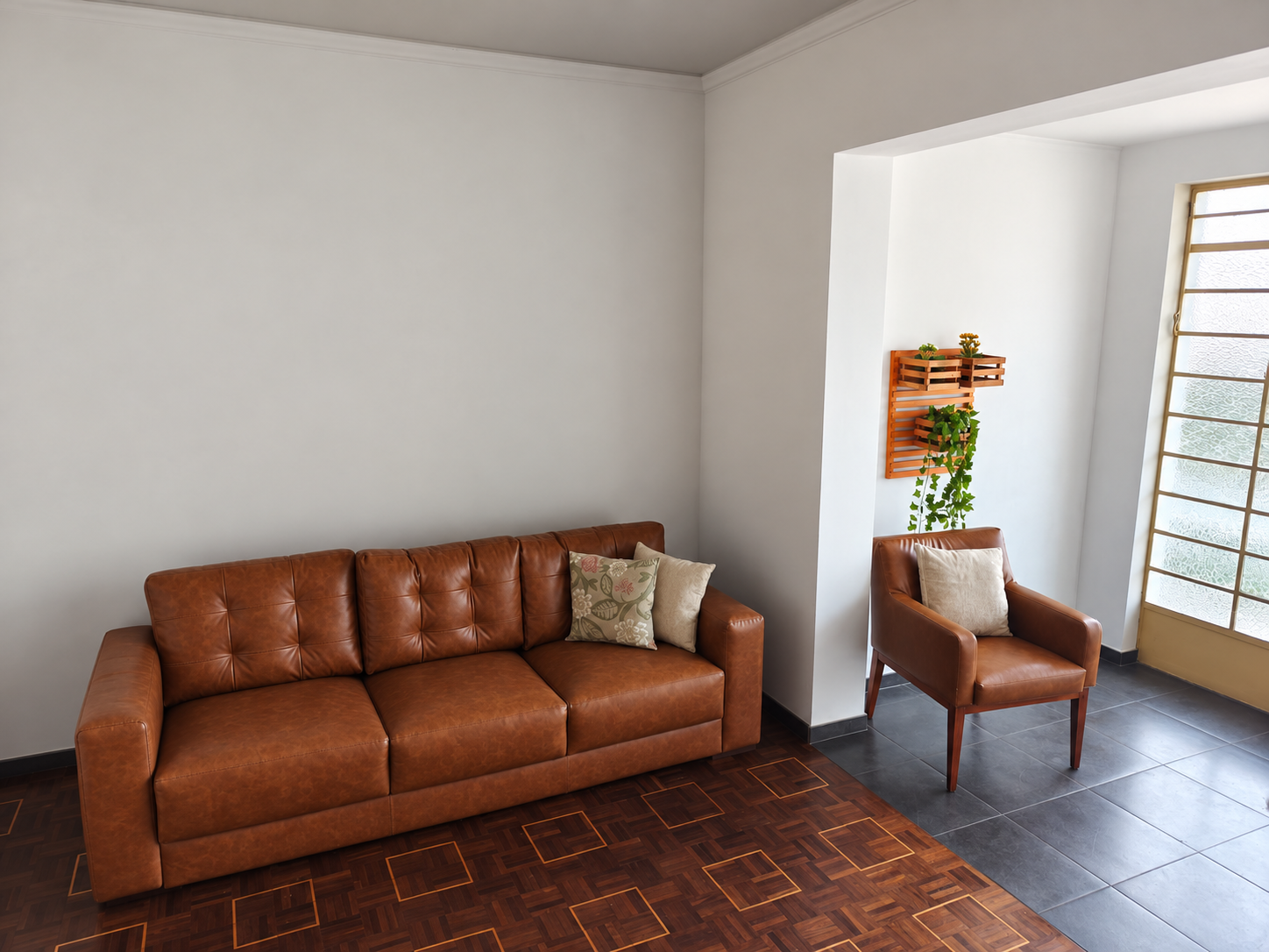 Sala de convivência da Tenerezza, com sofá, poltrona e plantas.